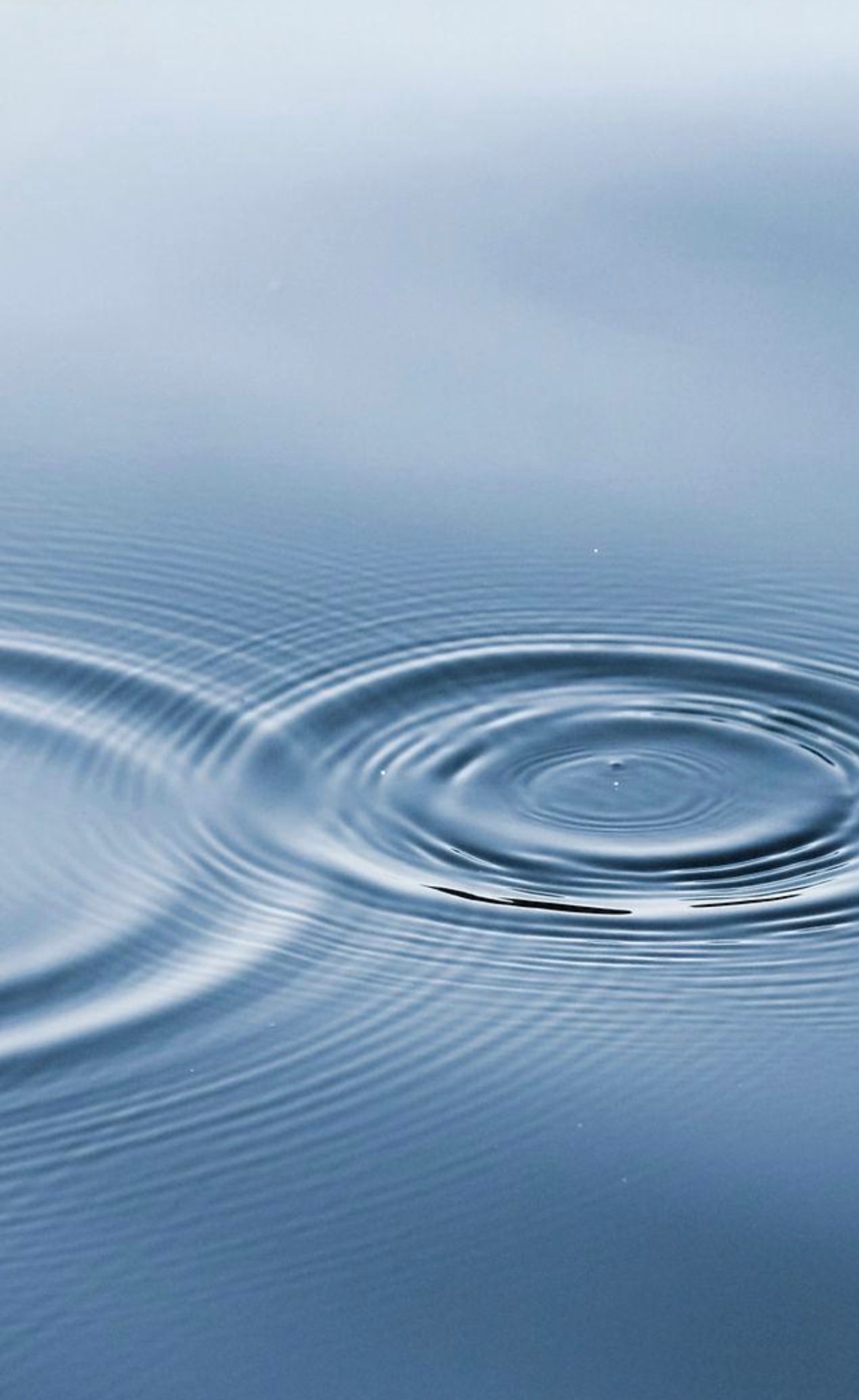 Concentric ripples spreading across still water